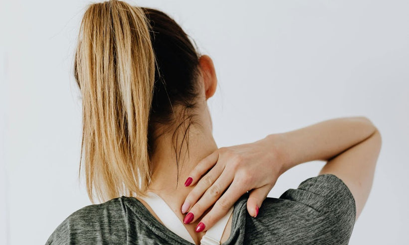 A woman in pain massages her back pain – Dr. Dabber
